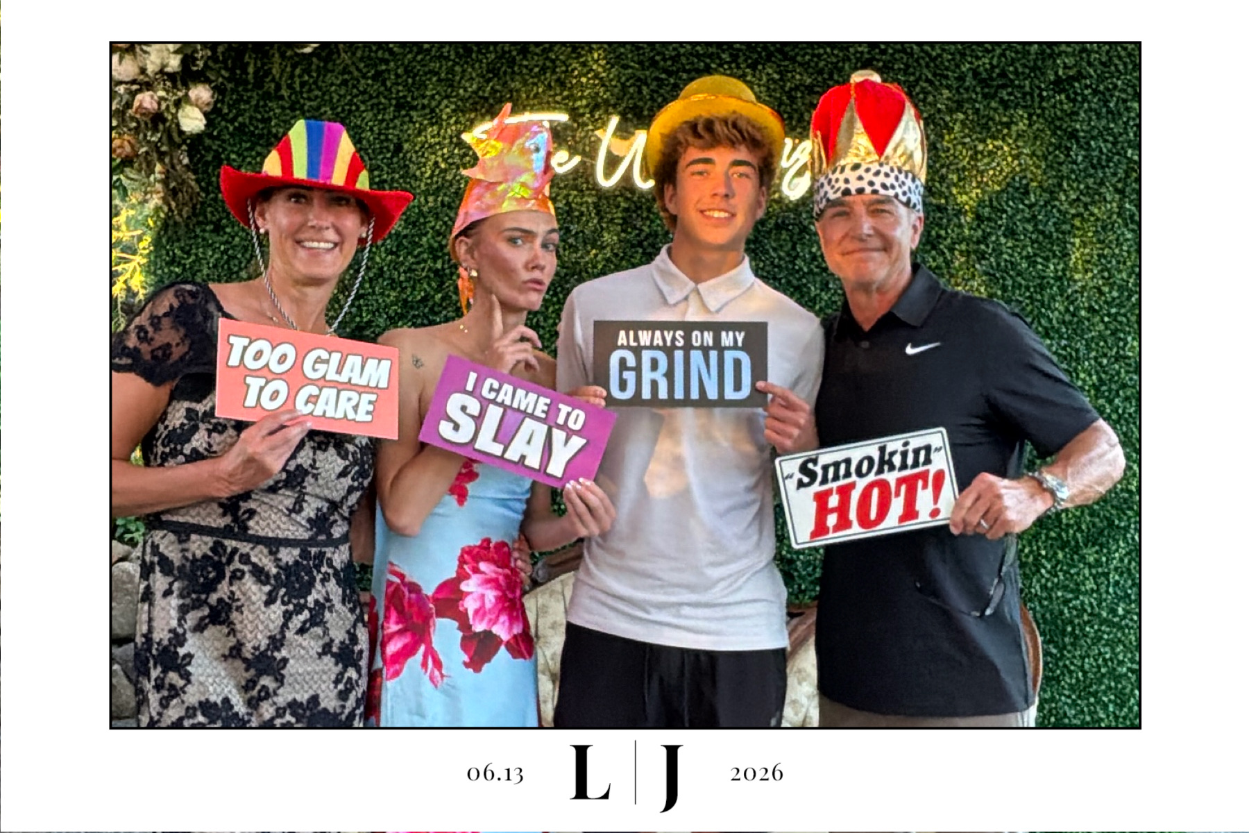 Four wedding guests pose with signs in a full Queen photo booth print from Silverton, Oregon
