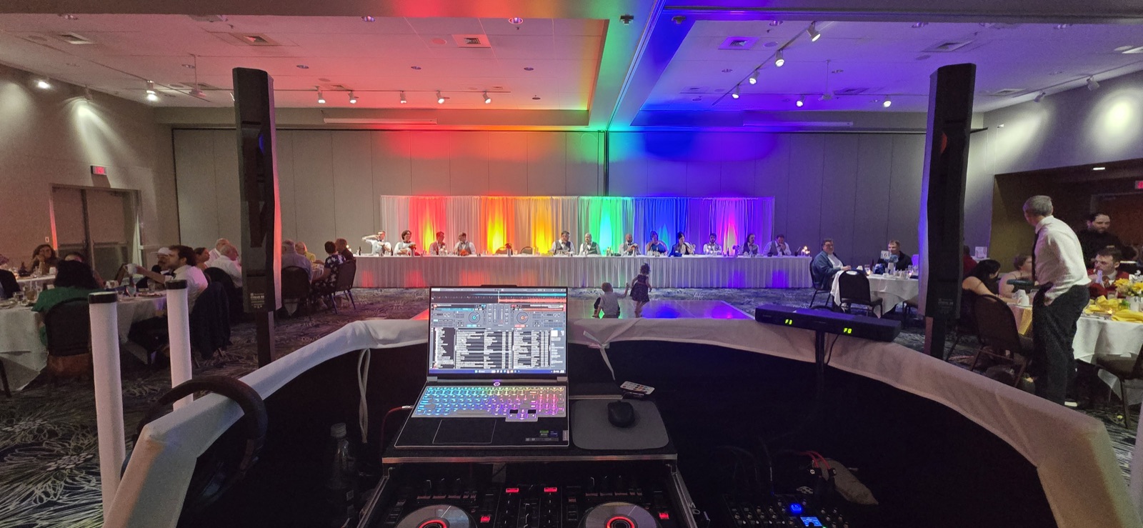 Ballroom reception in Salem with rainbow uplighting behind the head table
