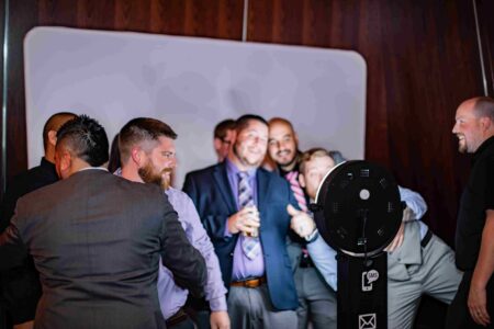 Photo booth guests are photographed laughing while taking photos at the Salem Conventer Center - Willamette Ballroom.