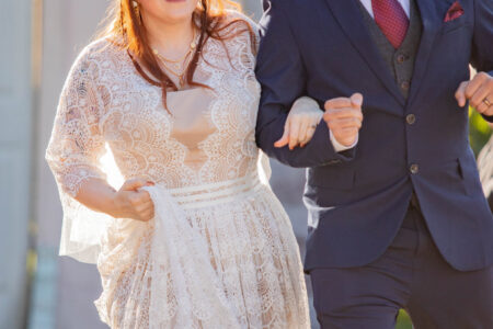 A couple celebrates as they leave their wedding ceremony.