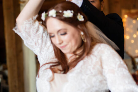 A groom spins his bride for their first dance