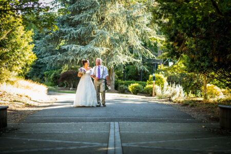 A wedding couple photographed in the distance on a street in the PNW.