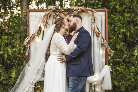 A wedding couple share their first kiss.