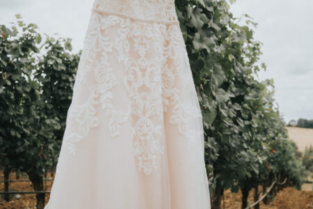 Wedding gown hung artistically at Oregon vineyard wedding photography detail shot