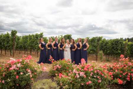 Bride with seven bridesmaids in navy dresses formal portrait at Oregon vineyard wedding